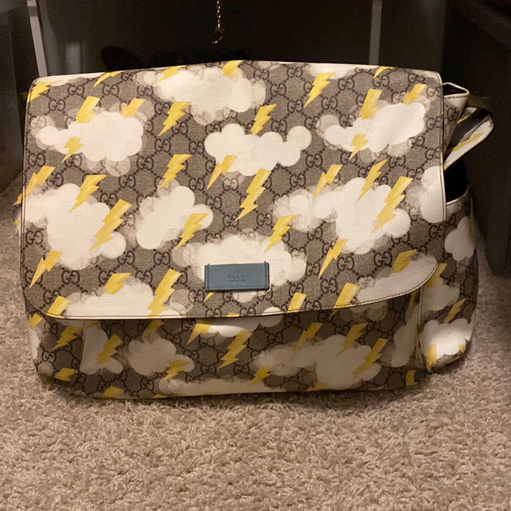 Gucci lighting bult diaper bag comes with a gucci imprint diaper changer.